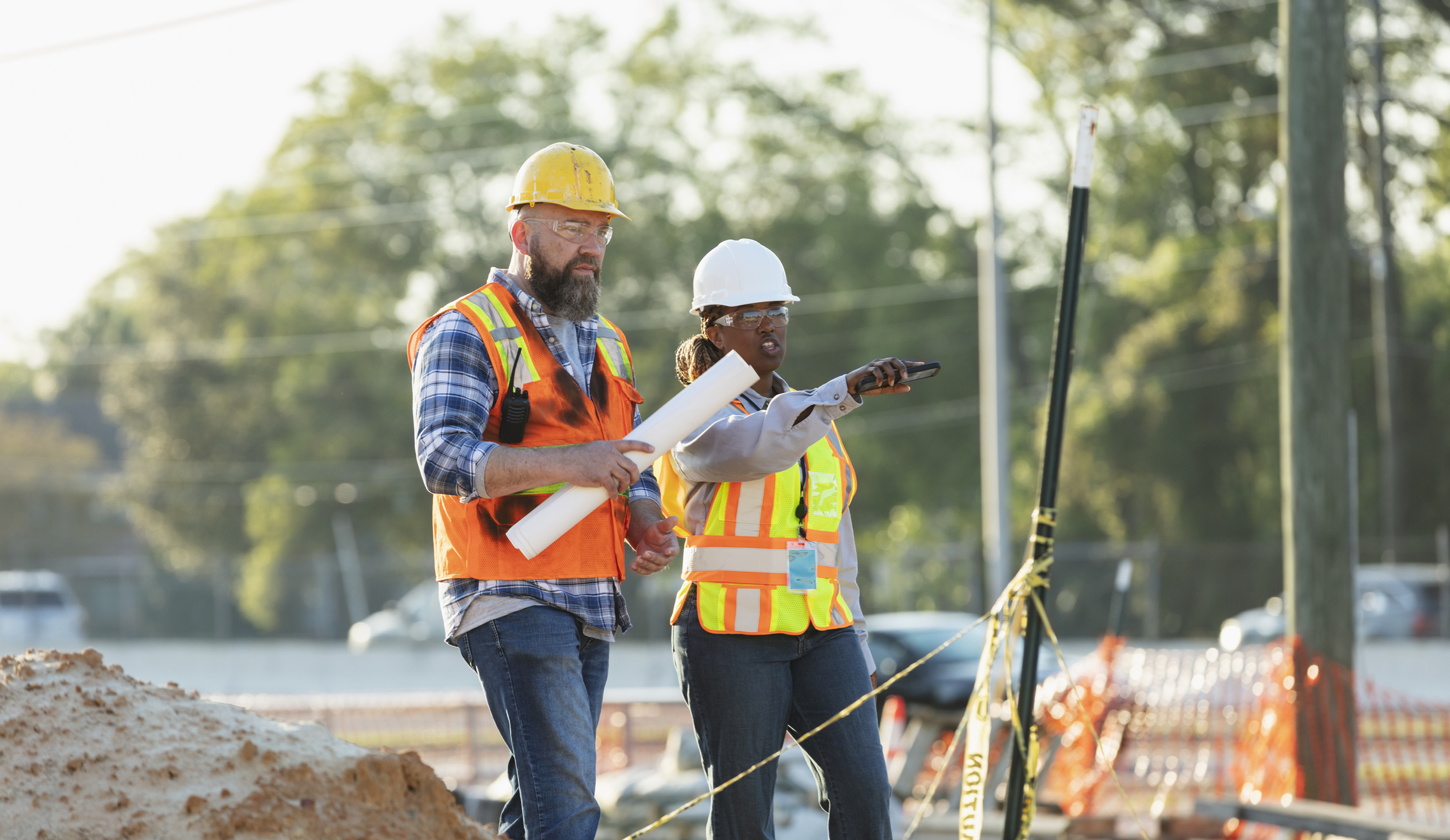 Female construction worker with coworker at job site